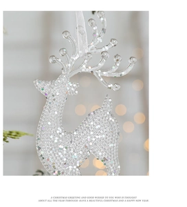 Close-up of clear acrylic reindeer ornament with silver glitter for Christmas tree decor