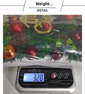 Detailed view of Christmas decoration with red and gold baubles and natural pine cones