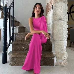 Detail of rose red one-shoulder top with large bow accent and matching wide-leg trousers