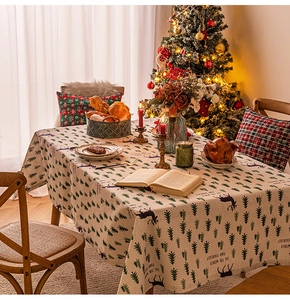 Detail of Christmas tablecloth with deer pattern and See The World Find Yourself text
