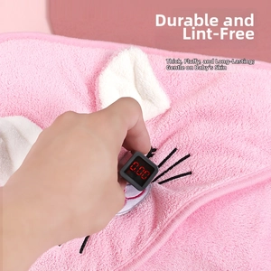 Detailed macro view of pink coral fleece fabric texture with safety test meter