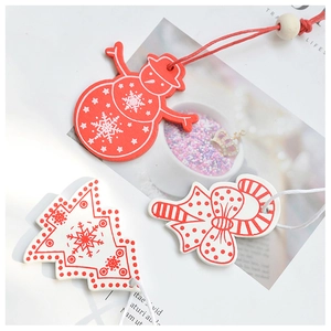 Detail of red and white wooden Christmas ornaments with snowflake patterns and strings