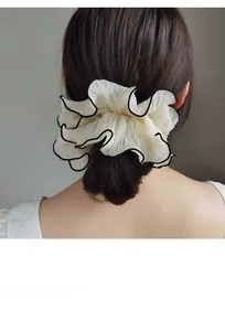 Detail of cream organza oversized scrunchie with black trim on brunette hair ponytail