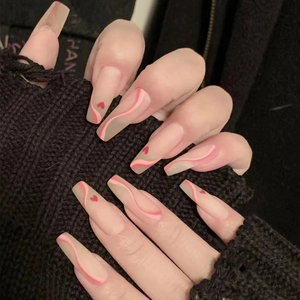 Long ballerina press-on nails with nude base, pink waves, and tiny red hearts