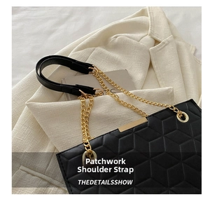 Detail view of black quilted shoulder bag with gold chain strap on tweed blazer