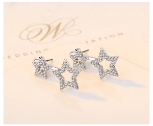 Detailed macro view of S925 sterling silver earrings with sparkling zircon star design