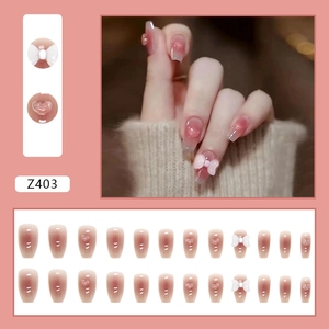Pink gradient press-on nails with 3D bows and heart gems in a 24-piece full set
