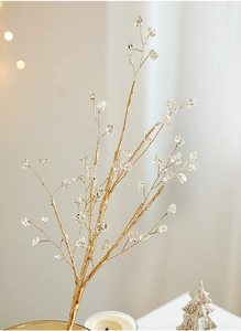 Close-up of golden decorative branches with clear crystal beads for Christmas decor