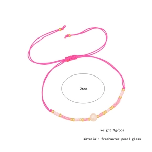 Detail view of woven pink bracelet with freshwater pearl and dimensions text