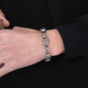 Macro detail of retro engraved stainless steel links and clasp on a men's bracelet
