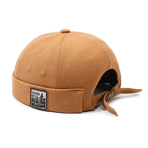 Classic caramel canvas docker hat with adjustable metal buckle and side patch detail