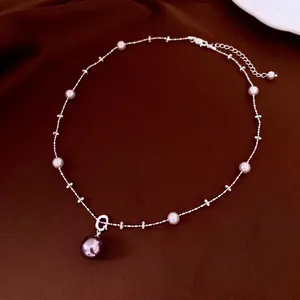 French style pearl and zircon lariat necklace with large brown pearl on brown velvet