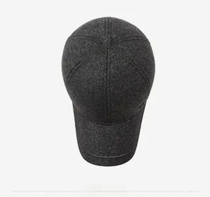Top view of dark grey winter baseball cap showing textured wool fabric and peak stitching