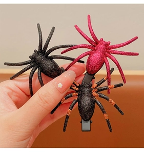 Set of three glitter spider hair clips in black, red, and orange for Halloween costumes