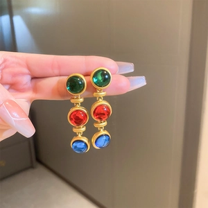 Détails de boucles d'oreilles vintage style palais avec perles et pierres colorées