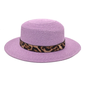 Dettaglio cappello di paglia lavanda con nastro leopardato e borchia dorata elegante