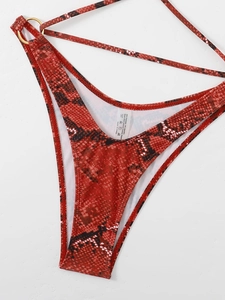 Detail of red and black snake print bikini bottom with metal ring and strap accents