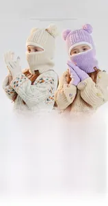 Detailed close-up of knitted winter hat with plush bear ears and matching warm gloves