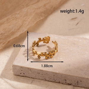 Adjustable golden stainless steel ring featuring a delicate hollow leaf pattern design