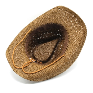 Detail of hollow woven texture and inner sweatband on a brown straw cowboy sun hat