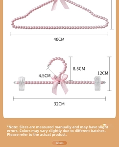 Detailed view of pink pearl hangers with ribbon bows and size specifications in CM