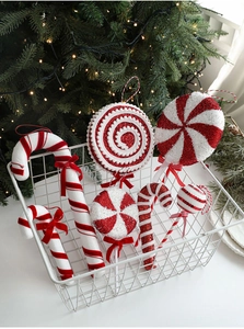 Macro shot of red and white candy cane foam ornaments in a white basket for Christmas decor