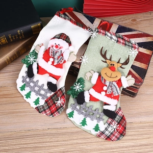 Set of 2 Christmas stockings with snowman and reindeer patches on a festive background