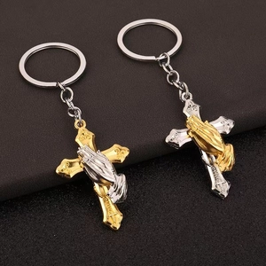 Cross keychain with praying hands charm in gold and silver embossed metal style