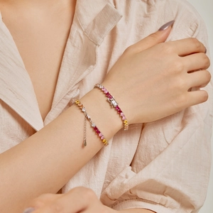 Close-up of elegant S925 silver bracelet featuring colorful heart-shaped gemstones on wrist