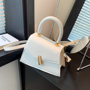 Minimalist white PU leather handbag with trapezoid flap design and gold metal hardware