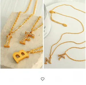 Detail of elegant gold titanium steel necklaces with crystal letter pendants and O-chain