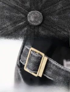 Macro view of stitching detail on grey washed cotton cap and adjustable metal buckle strap
