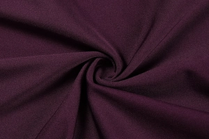 Macro detail of wine red lace fabric texture with silky finish and draping effects