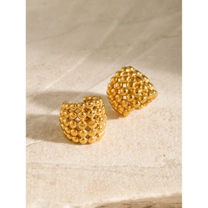 Polished 18k gold plated honeycomb bubble textured hoop earrings on stone display