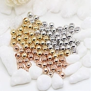 Detailed macro view of mixed gold and silver DIY metal beads for handmade jewelry making