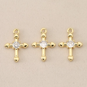 Detailed macro view of three 18K gold plated Baroque cross pendants with round gemstones