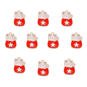 Detailed view of ten lucky cat alloy charms with red enamel stars for DIY jewelry