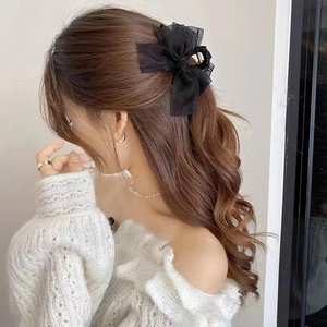 Elegant black mesh bow hair claw clip for women shown on model for a sophisticated look