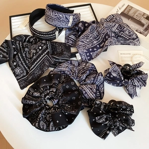 Vue à plat d'accessoires de coiffure bandana bleu marine incluant serre-tête et chouchous