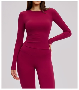 Detail of high-stretch wine red seamless yoga set with brushed texture and stitching