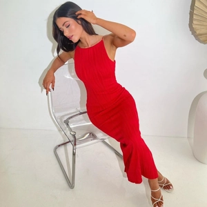 Detailed close-up of a red ribbed maxi dress featuring thin straps and bodycon fit