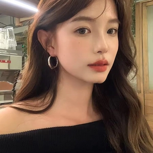 Irregular silver hoop earrings for women with minimalist geometric circular design