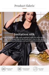 Detail of black silk satin robe showing smooth fabric texture and laundry care instructions