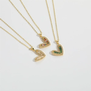 Three elegant heart-shaped gold necklaces with colorful zircon stones on white background