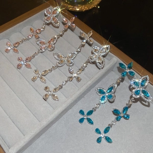 Sparkling butterfly tassel earrings with crystals in pink, blue, and champagne gold