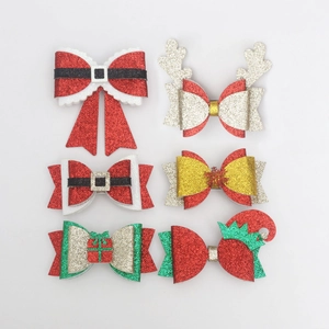 Detail of Christmas glitter hair clips set featuring reindeer antlers and snowflakes motifs