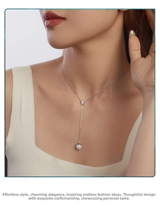 Close-up of S925 silver butterfly necklace with white pearl pendant on neck