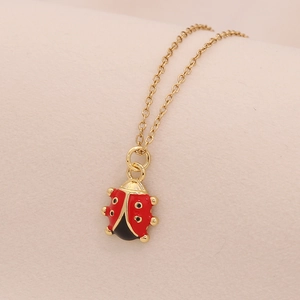 Collana con ciondolo a coccinella dorata con smalto rosso e zirconi