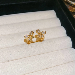 Macro detail of gold butterfly ring featuring pave-set cubic zirconia on velvet stand
