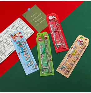 Detail of Christmas stationery set with pencils, ruler, eraser, and sharpener on red background